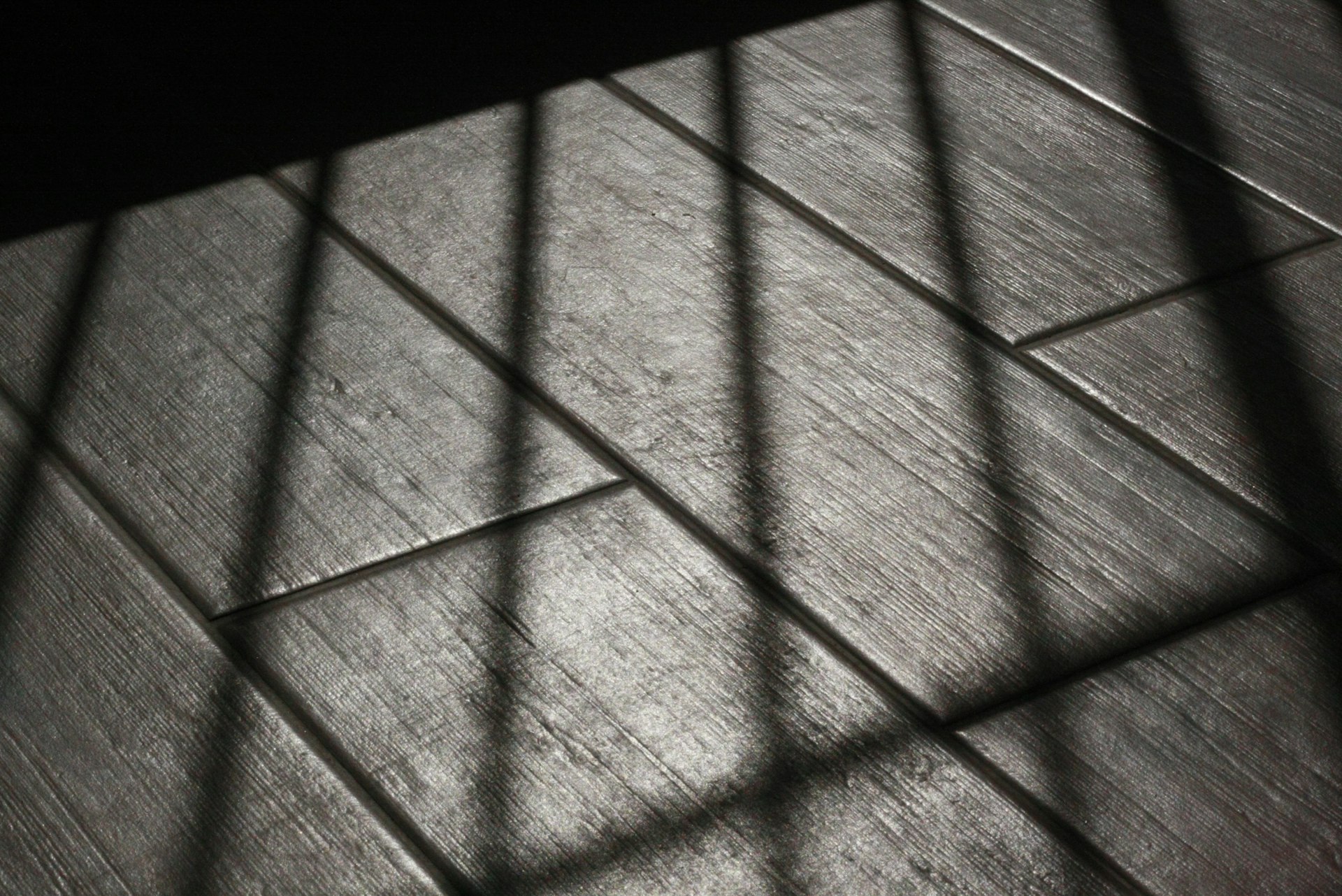 The floor is made of wood and has bars on it